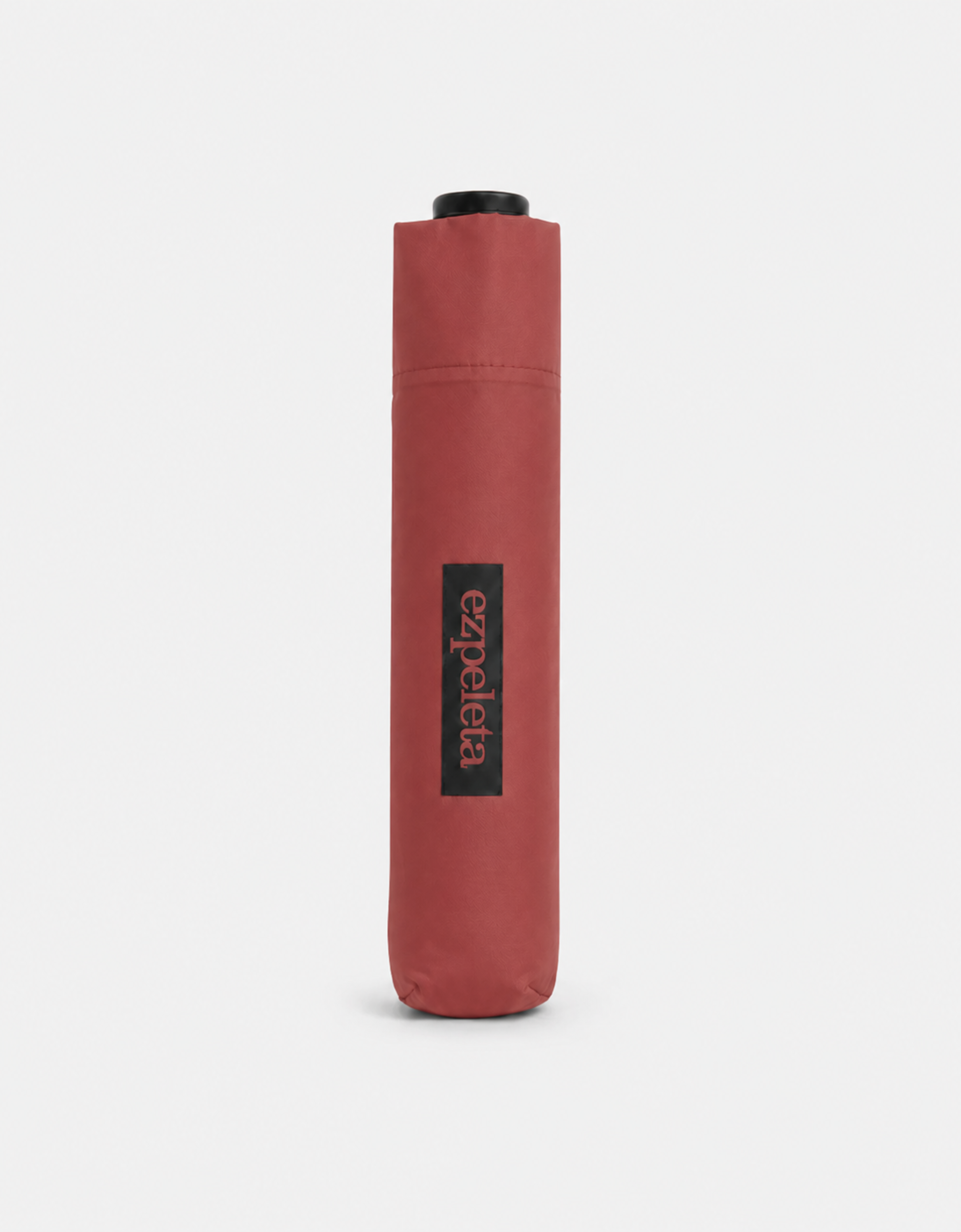 Paraguas ultraligero plegable de la marca EZPELETA abierto, con estructura compacta y tela resistente a la lluvia, en color oscuro.